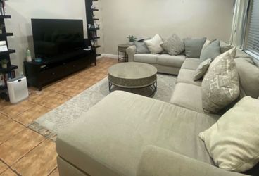 Sectional living room couch with two round tables