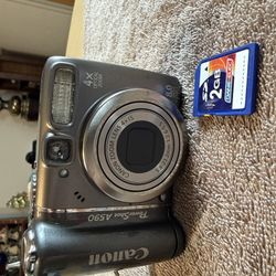 Canon PowerShot A590 IS 8.0 MP Digital Camera - Silver with 2 GB sd card. Tested. Working great. Uses two AA batteries. 