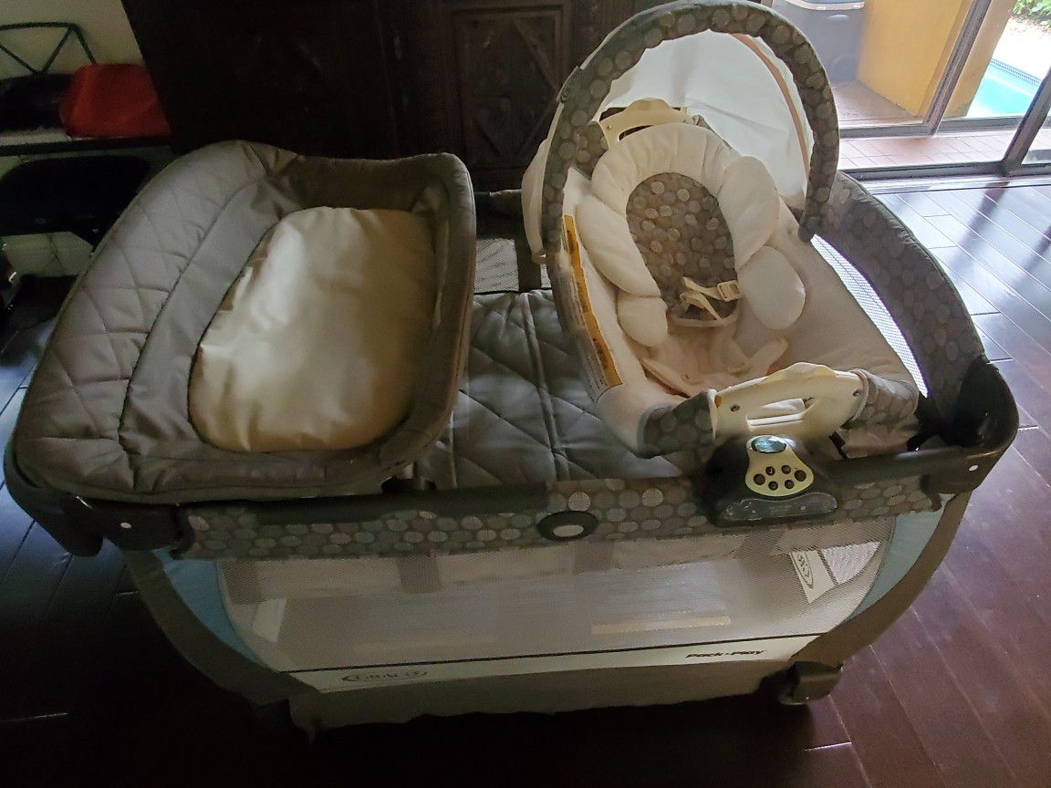 Graco travel bed with changing station, bassinette and changing table.