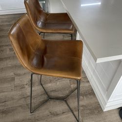 West Elm Real Genuine Leather matching high bar stools (floor to seat: 30”).  In great used condition. Price is for both. 