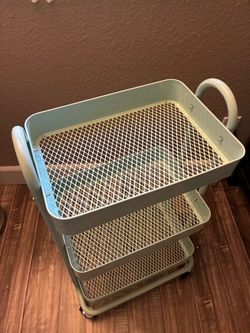 Light green metal organizer with wheels in great condition
