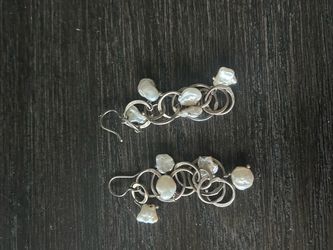 handmade cluster earrings feature flat, organic freshwater Keshi pearls woven into interlocking metallic rings, likely made of 925 sterling silver or 