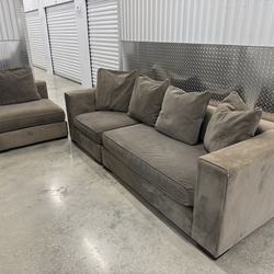 Two-piece sofa and armchair set in gray velvet.