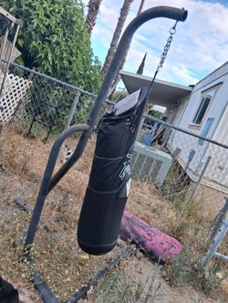Punching bag stand and bag but it is ripped in the front