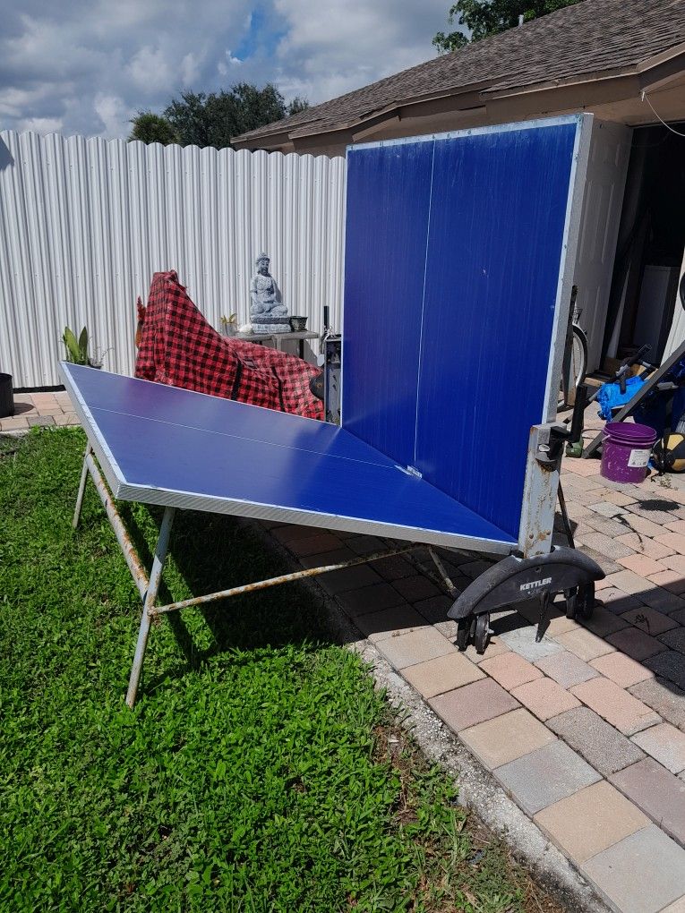 Ping Pong Table With Ping Pong Paddles And Some Balls