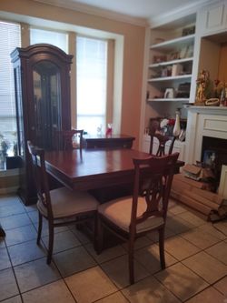 Teakwood  dining room set table and 4 chairs  buffet china and leaf .  In great condition. Newly reuphos therefore chairs.