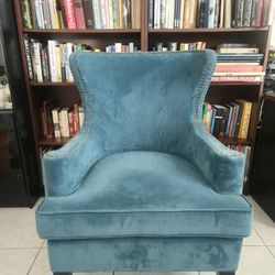 Elegant blue chair with nailhead trim.