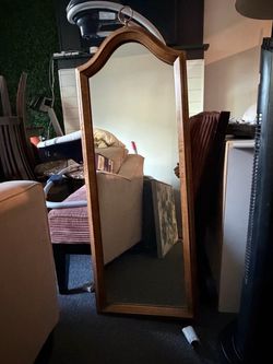 Full-length mirror with a wooden frame. In good condition and ready to hang. Pickup in Bothell.
