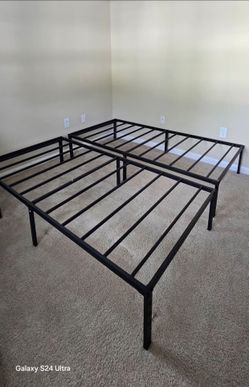 New twin metal bed frame with mattresses.