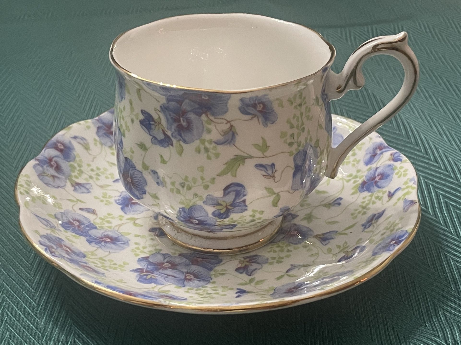 Royal Albert bone china teacup and saucer with blue pansy chintz pattern.