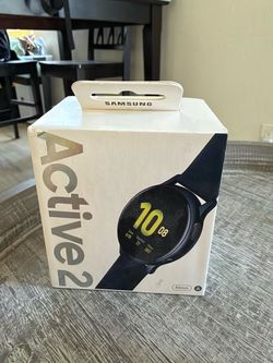 Black Samsung Galaxy Watch Active2 is a 40mm smartwatch with an aluminum case and a silicone band. It has a circular touch screen and includes the ori
