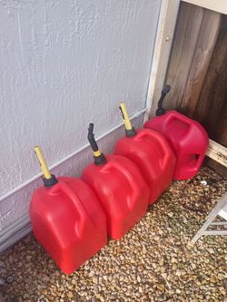 Four five gallon gas cans