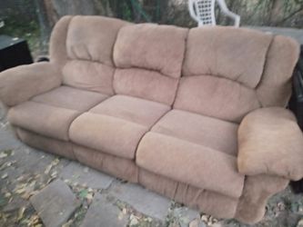 Couch with dual recliners ans a storage ottoman