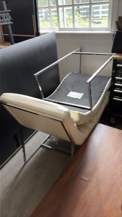 Two white lounge faux leather chairs