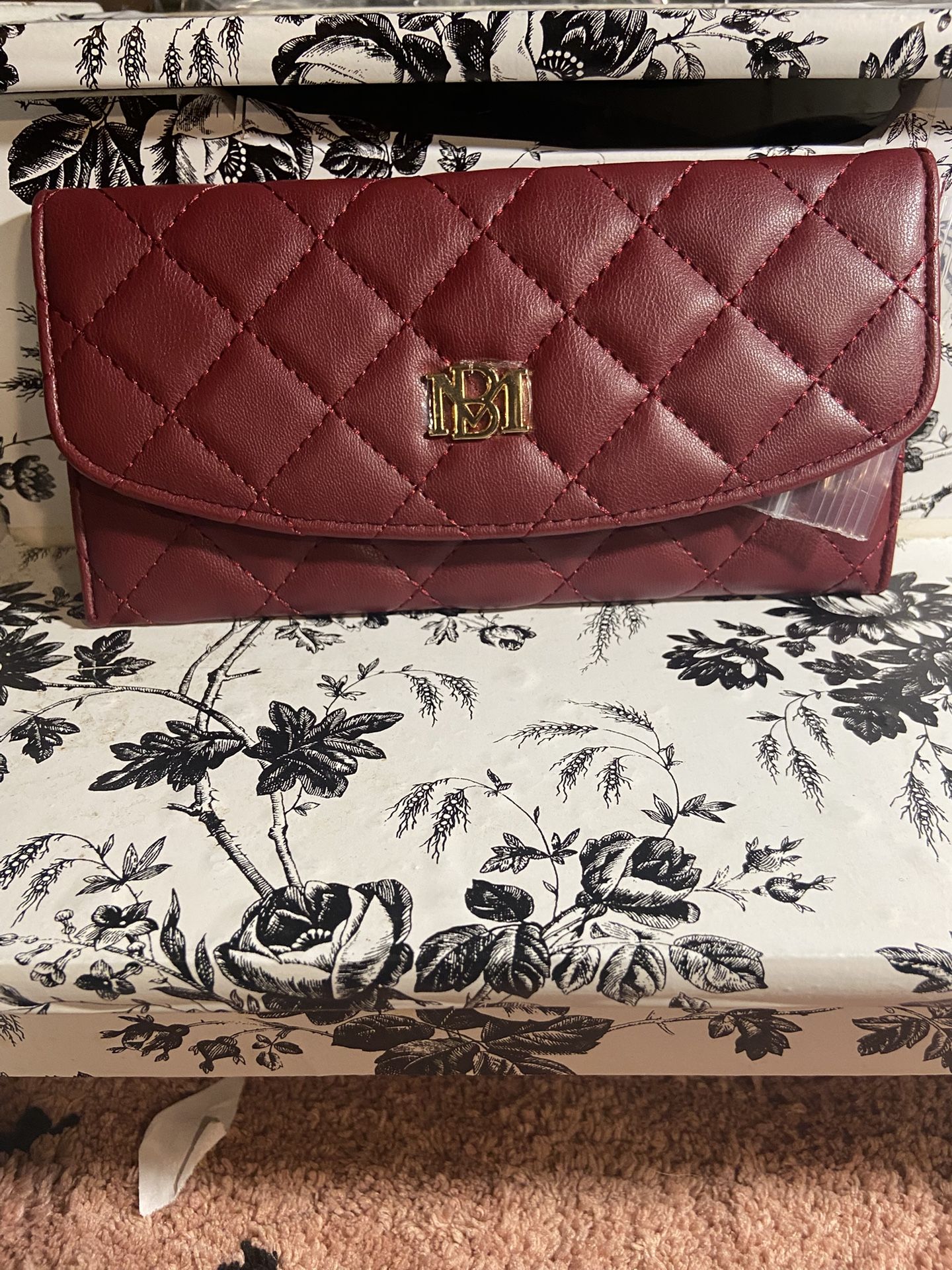 Authentic Brand New BADGLEY Mischka leather wallet in the color burgundy with gold hardware
