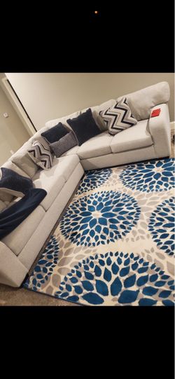 Sectional, coffee table, rug, painting