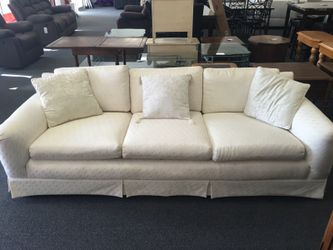 White sofa with cushions in good condition