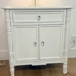 White vintage-style French Provincial / Hollywood Regency nightstand with 1 drawer, 2-door cabinet storage, and custom acrylic knobs.