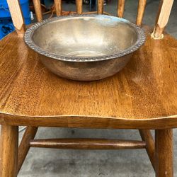 Based on the visual characteristics, the item appears to be a vintage silver-plated bowl with a decorative rim. This type of bowl is often referred to