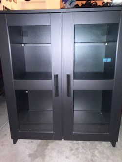 Black wood and glass curio cabinet.