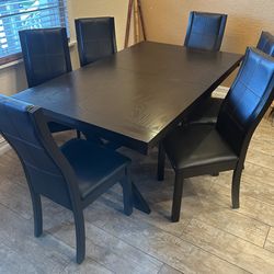 6 seat Dark wood dining table w/ 6 pleather chairs