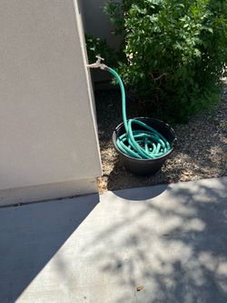 Green Garden Hose with Black Hose Pot