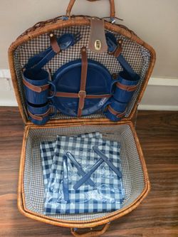 This is a vintage-style dome-top wicker picnic basket set, configured with a dinnerware service for four.