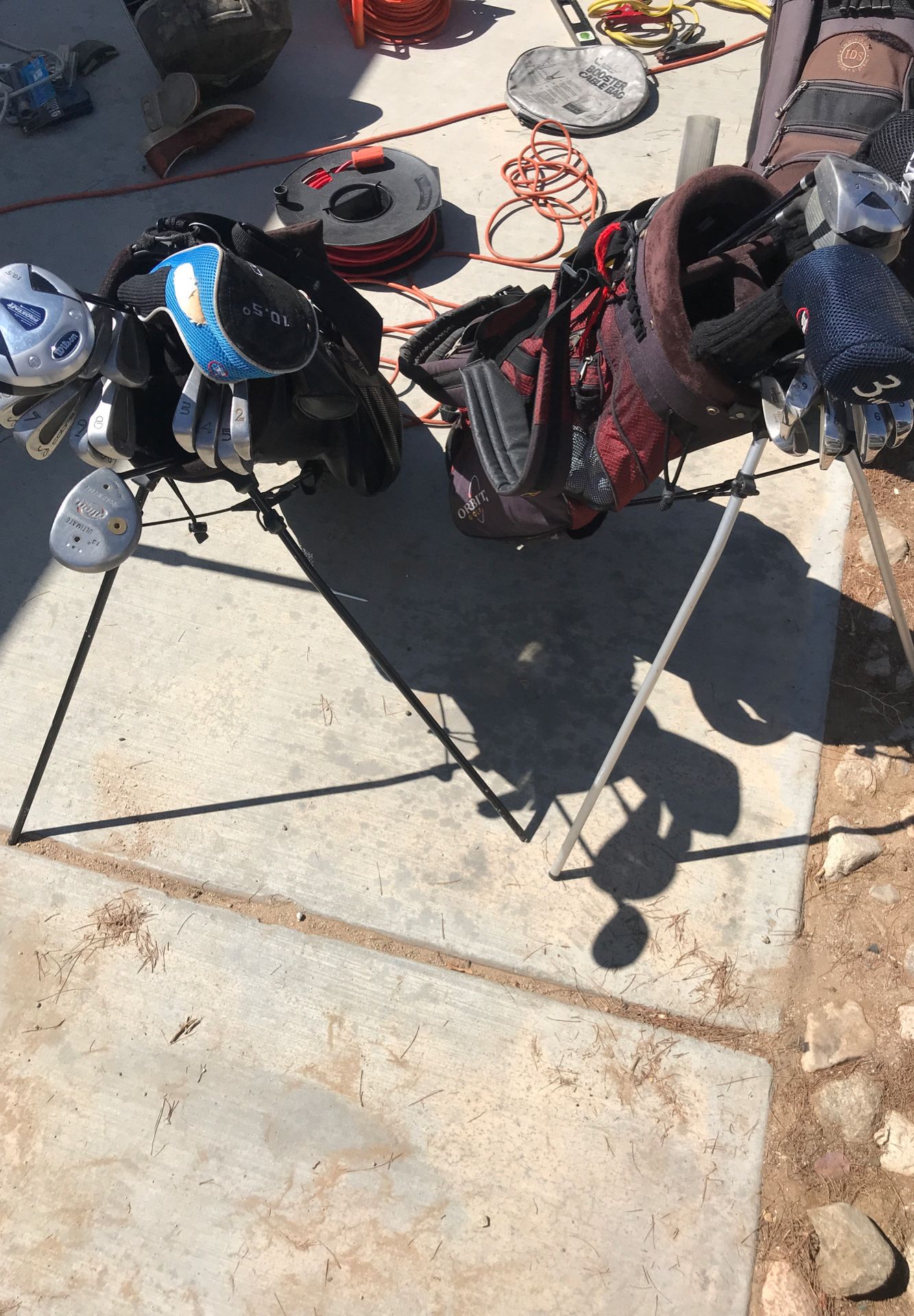 Two sets of golf clubs