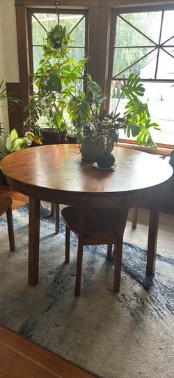 Nesting round wooden dining table with 4 chairs