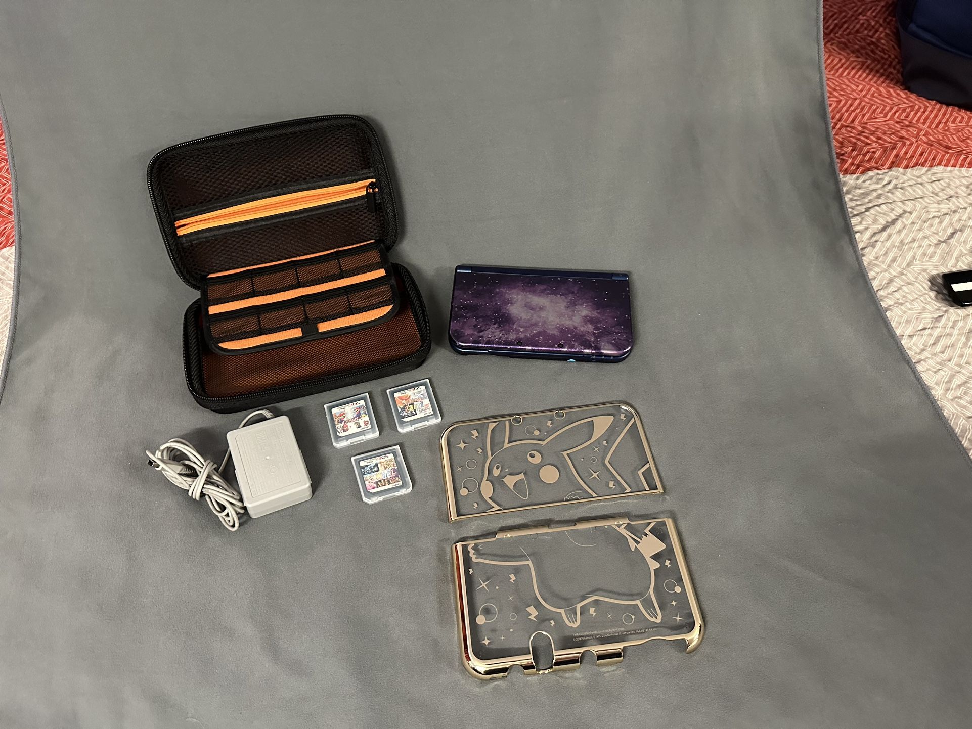 Nintendo 3DS XL Galaxy Console w/ 3 Cases + HORI PIKACHU Premium Gold & Games