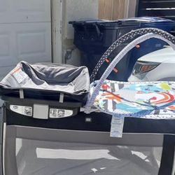 Gently used play pin with diaper changing table/diaper storage