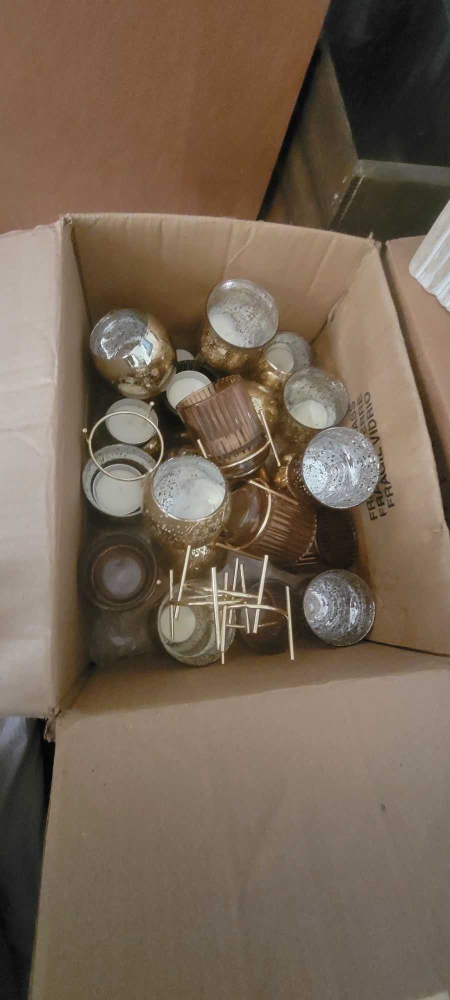 2 boxes of gold candle holders 