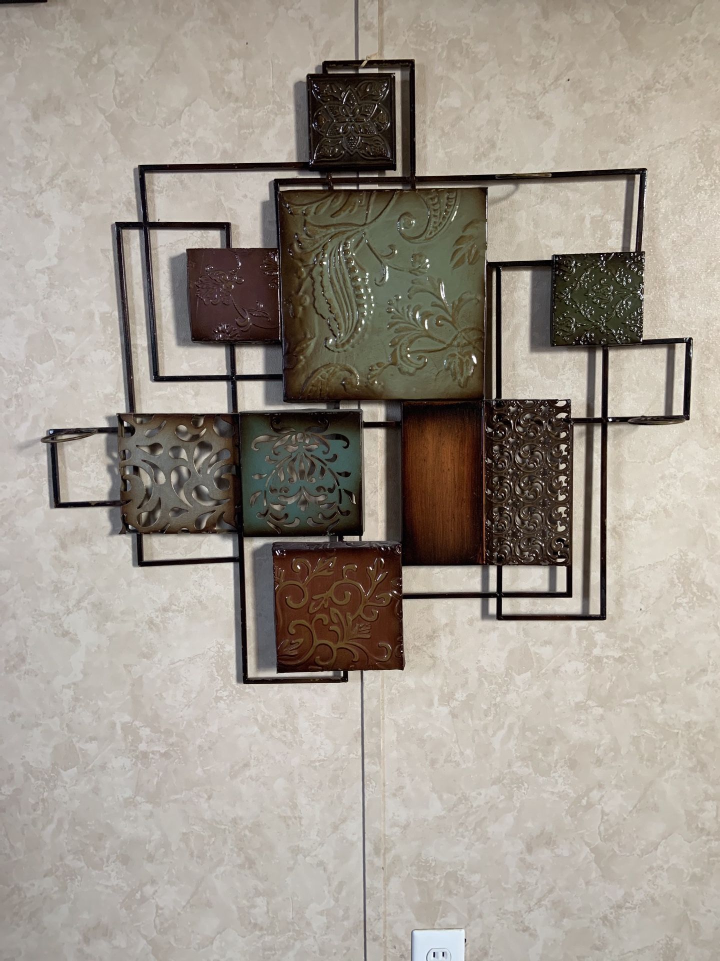 Beautiful Metal Wall Art with candle holders.