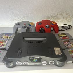 Nintendo With Two Controllers And Games 