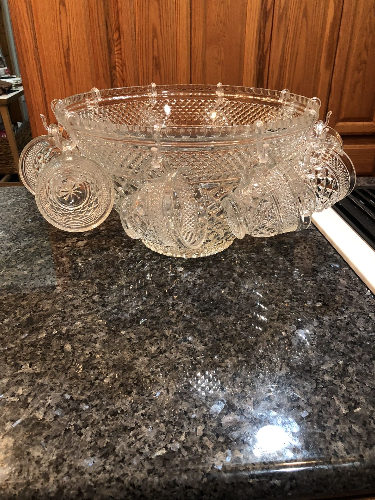 Vintage Glass Punch Bowl with 8 Cups.  Very pretty cut design.  No cracks or chips or brand.  No hooks included for the cups.  Preowned excellent cond