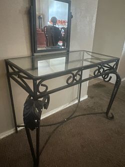 glass-top console table with mirror