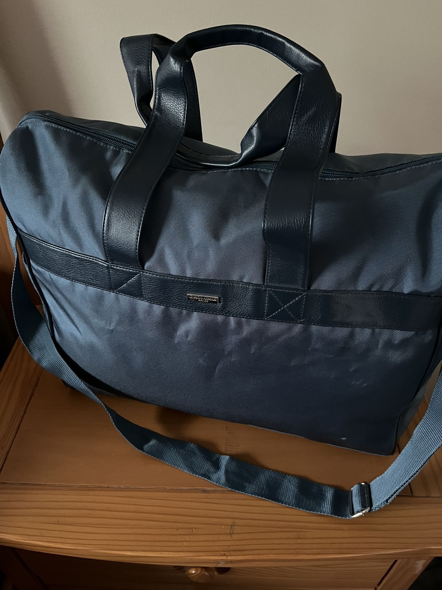 It’s Very Good Duffle Bag Made By GORGIO Armani. The Color Is Teal.
