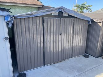 Sizzim 10 ft W x 8 ft D metal storage shed in like new usable condition