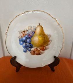 Vintage Schumann Arzberg porcelain Fruit Plate Features a Central Motif of a Yellow Pear, Blue Grapes, and Hazelnuts w/ a Scalloped Gold Rim.
