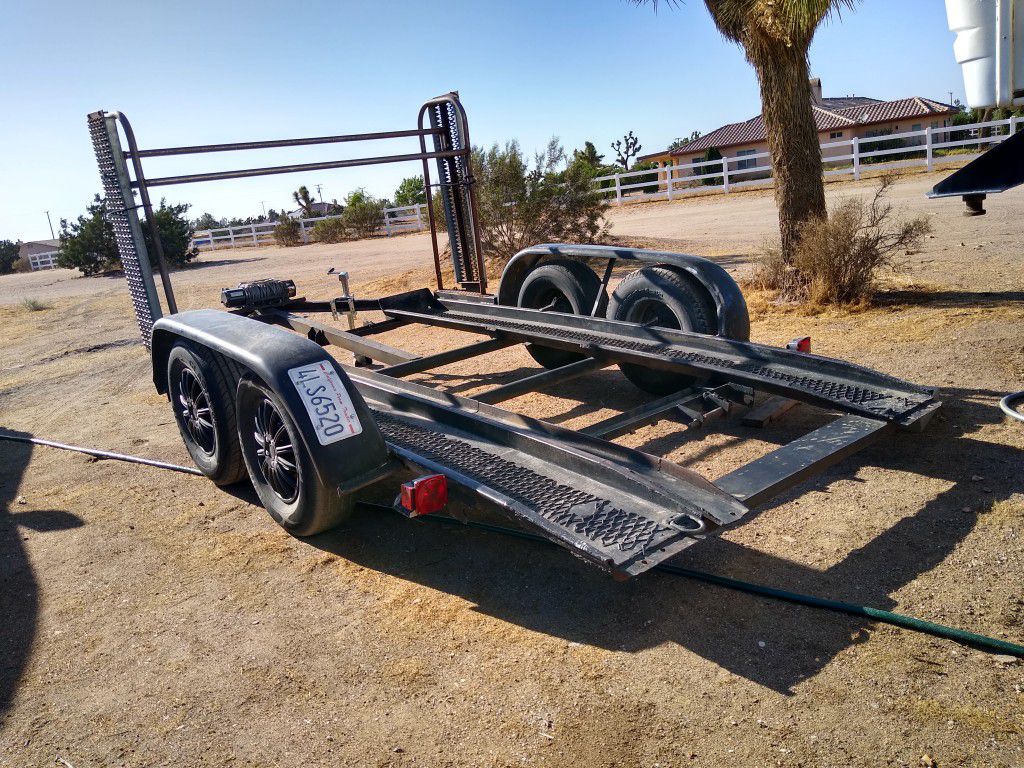 Car trailer with winch has tire rack and ramps 16 ft