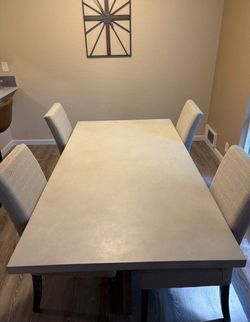 Concrete dining table with four chairs