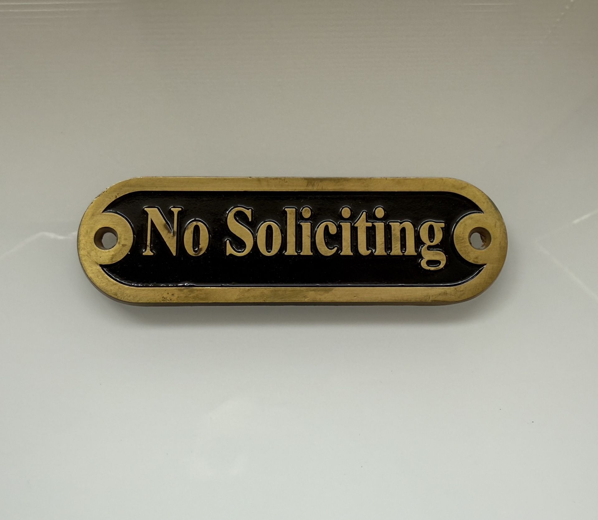 metal “No Soliciting” sign