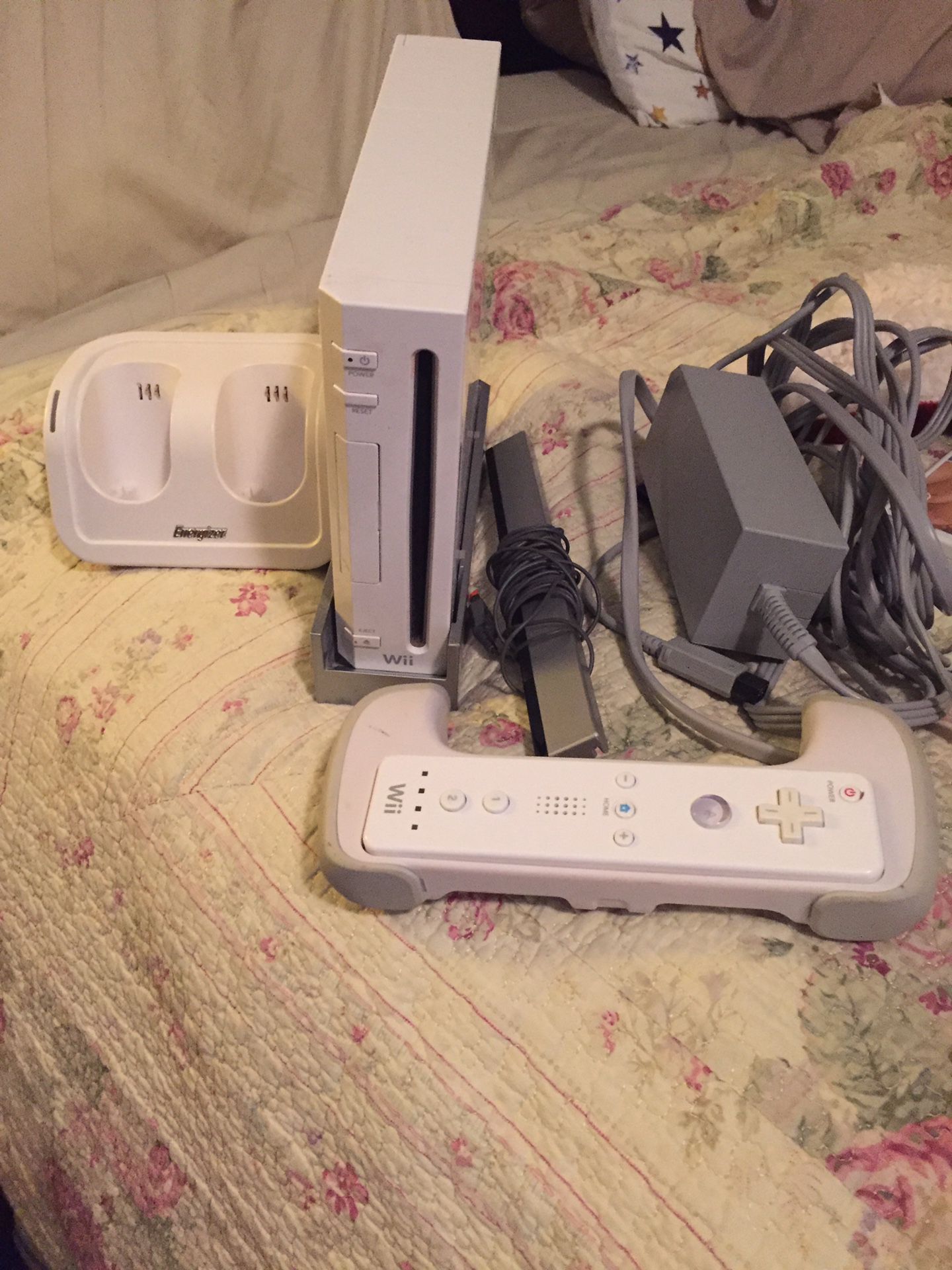 Wii Console with controller and controller stand for 2 controllers, stand for the console and controller handle for racing games!! Also have 2 games