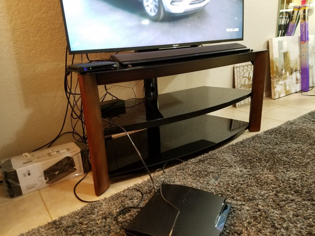 TV Stand with 3-in-1 swivel back mount. Supports up to 65 in.