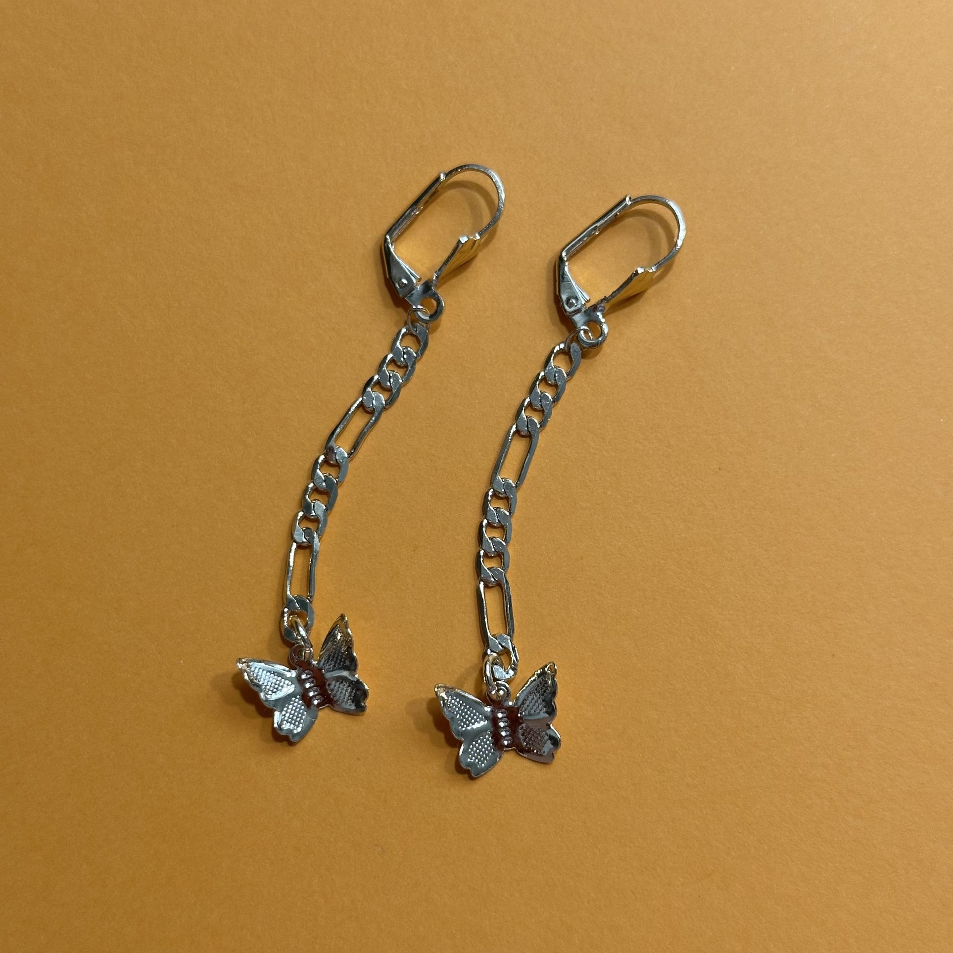 Gold tone chain dangling butterfly earrings