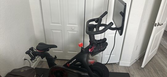 Peloton Bike with touchscreen, mat, and cycling shoes. Good working condition. $650 OBO