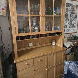 Spacious Wooden Display Cabinet With Glass Doors And Multiple Drawers