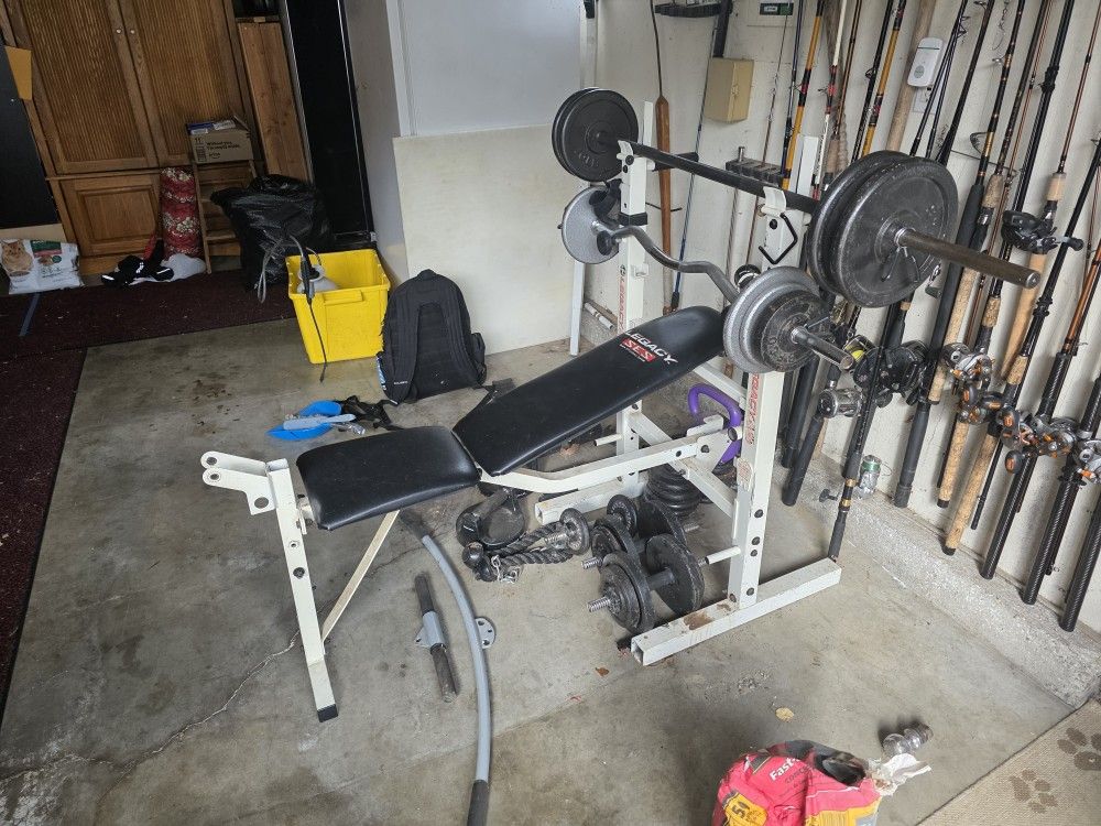  Great Shape No Tears In The Bench Comes With Two Straight Bars And One Curl Bar . Bench Has Pull Down Pulley Accessory 