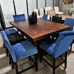 Only $999! Brand New 9 Piece Counter height Dining Set. One table and eight chairs for $999  