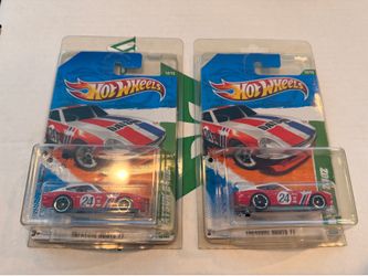 A pair of 2011 Hot Wheels Regular Treasure Hunt Datsun 240Z die-cast cars